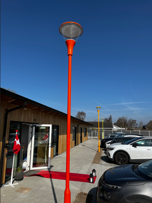 Lygtepæle ved p-plads i forskellige farver.